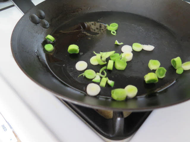 Green garlic in pan